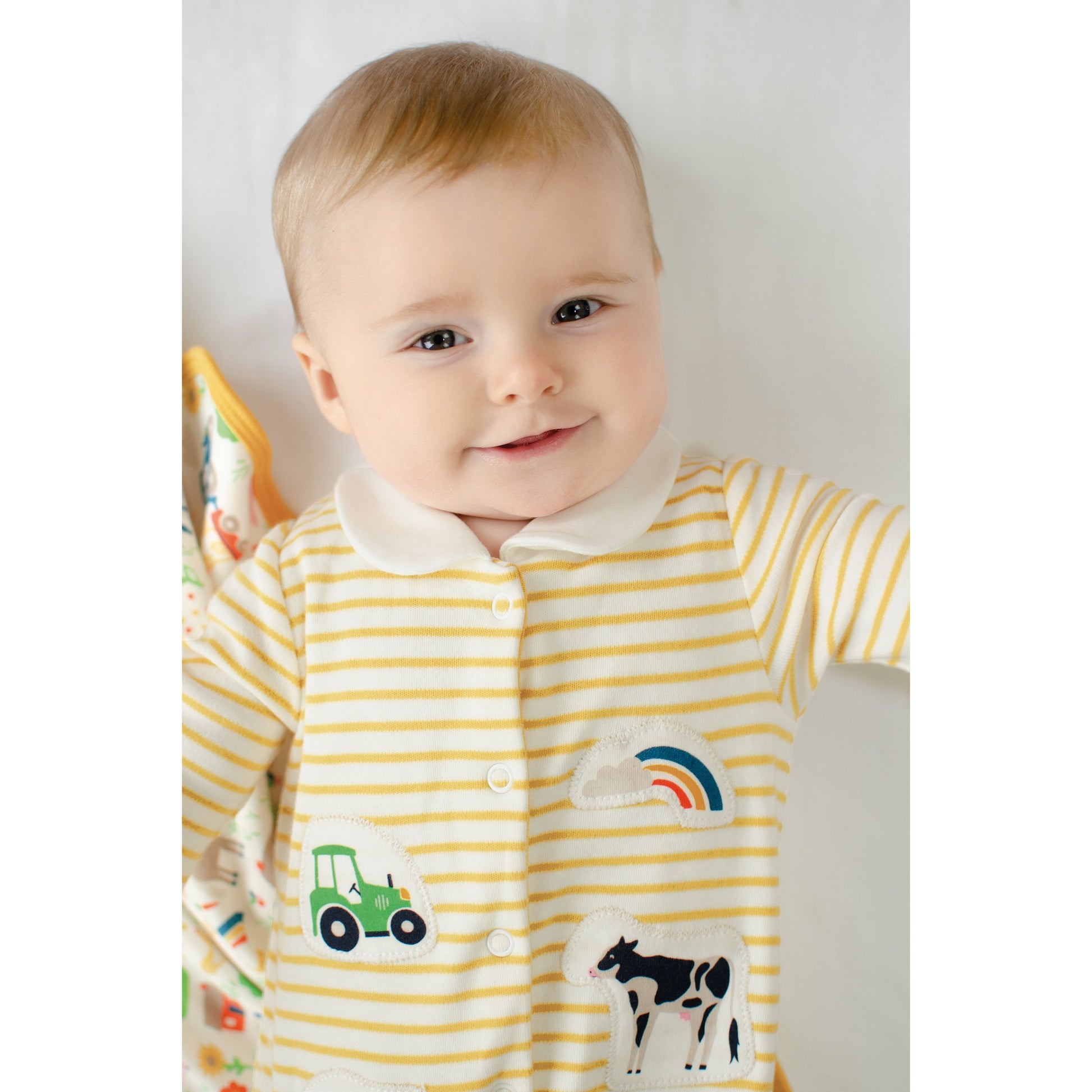 Baby wearing Little Collared Babygrow by Frugi