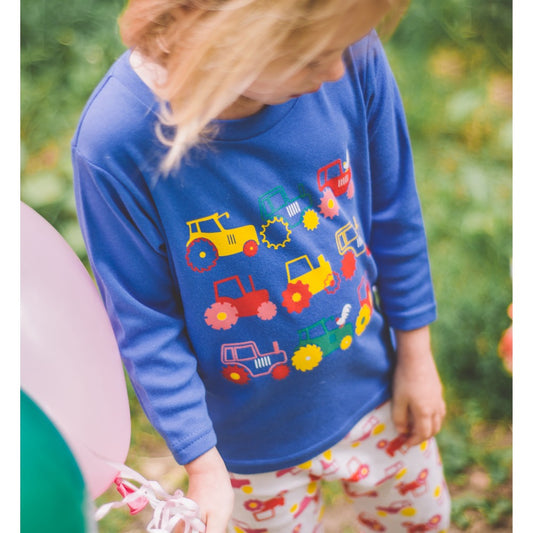 Little girl wearing Long Sleeved Tractor T-shirt by Toucan Blue | Cotswold Baby Co