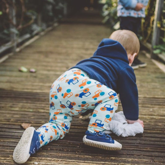 toddler wearing aqua cuffed tractor leggings | Cotswold Baby Co